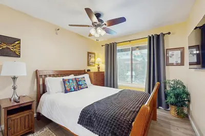 a bedroom with a bed and a ceiling fan at WilderNest in Stateline