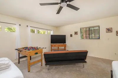 a living room with a couch and a table at The Play Pen in Arnold