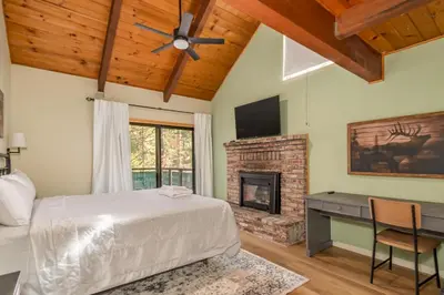 a bedroom with a bed and a fireplace at The Play Pen in Arnold