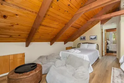 a living room with a bed and a couch at The Play Pen in Arnold