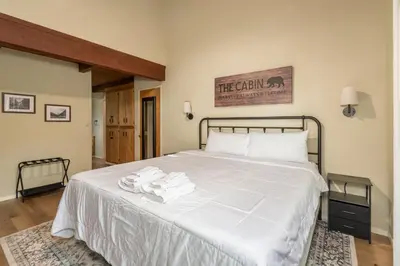 a bedroom with a bed with towels on it at The Play Pen in Arnold