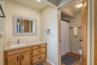 a bathroom with a sink and a mirror at The Play Pen in Arnold
