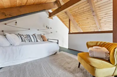 a bedroom with a white bed and a chair at HNC0691 - Tramway Treat home in Stateline