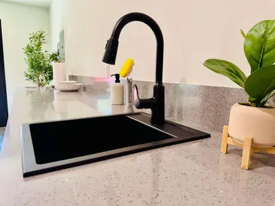 a kitchen counter with a sink and a faucet at 2 Homes by the River in Three Rivers