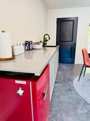 a kitchen with a red refrigerator and a red cabinet at 2 Homes by the River in Three Rivers