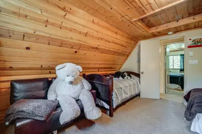 a large teddy bear sitting on a chair in a bedroom at Near Slopes, Donner Lake and Trails! Woodsy Retreat in Truckee
