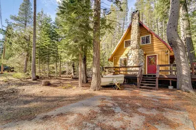 a log cabin in the woods with a porch at Near Slopes, Donner Lake and Trails! Woodsy Retreat in Truckee