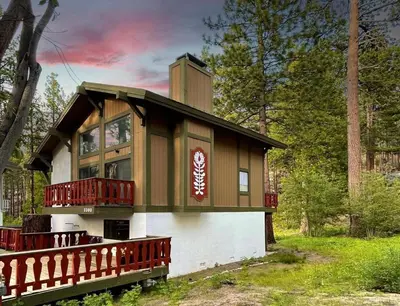 a house in the woods with a wrap around porch at 3390 Pine Hill Road home in South Lake Tahoe