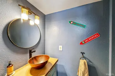 a bathroom with a wooden sink and a mirror at 3390 Pine Hill Road home in South Lake Tahoe