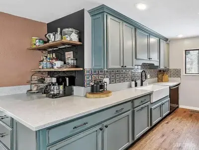 a kitchen with blue cabinets and white counter tops at 3390 Pine Hill Road home in South Lake Tahoe