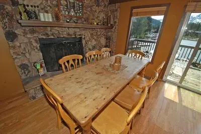a wooden table and chairs in a room with a fireplace at 584 Alpine Drive home in South Lake Tahoe