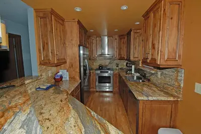 a large kitchen with wooden cabinets andsteel appliances at 584 Alpine Drive home in South Lake Tahoe