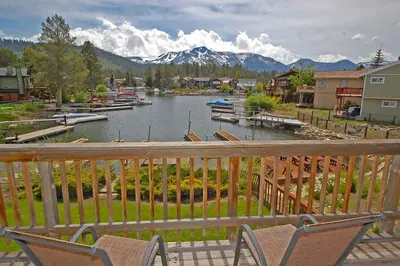 a balcony with a view of a river and mountains at 584 Alpine Drive home in South Lake Tahoe