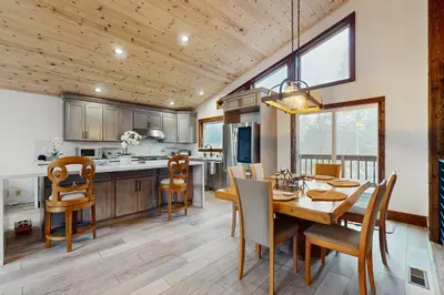 a kitchen and dining room with a table and chairs at Hillside Chalet in Truckee