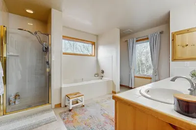 a bathroom with a tub and a sink and a shower at Hillside Chalet in Truckee