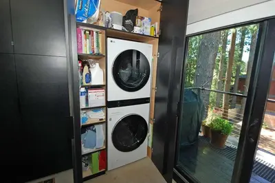 a washer and dryer next to a book shelf at 676 El Dorado Avenue home in South Lake Tahoe