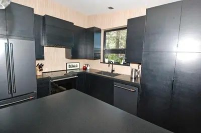 a kitchen with black cabinets and a black counter top at 676 El Dorado Avenue home in South Lake Tahoe