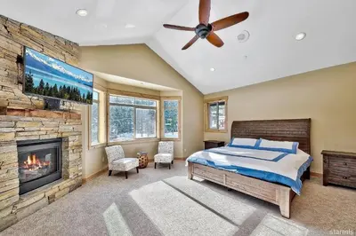 a bedroom with a bed and a fireplace at 539 Wintoon Drive home in South Lake Tahoe