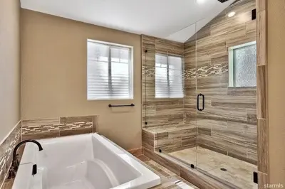 a large bathroom with a tub and a shower at 539 Wintoon Drive home in South Lake Tahoe