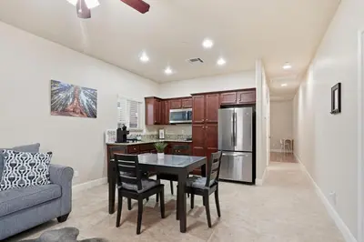 a kitchen and dining room with a table and a couch at Casa Cortez in Visalia