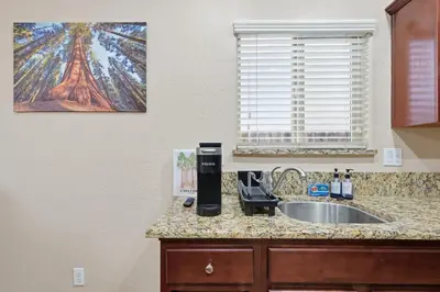 a kitchen counter with a sink and a coffee maker at Casa Cortez in Visalia