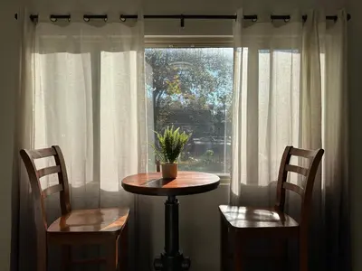 a table and two chairs in front of a window at Downtown 2 Bedrooms Full Kitchen & Easy Parking in Sacramento