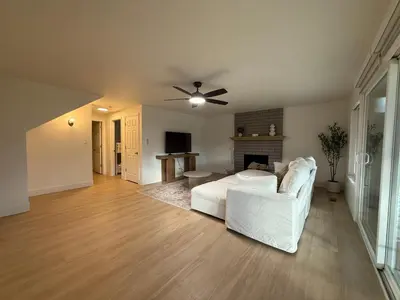 a living room with a white couch and a fireplace at New! Modern 4BR max 12 ppl, 5 mins to everything! in Reno