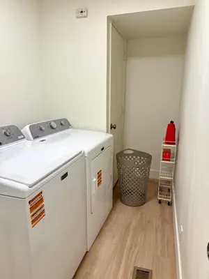 a laundry room with a washer and dryer at New! Modern 4BR max 12 ppl, 5 mins to everything! in Reno