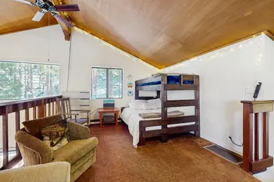 a bedroom with a bunk bed and a couch at Pine Hill Hideaway in South Lake Tahoe