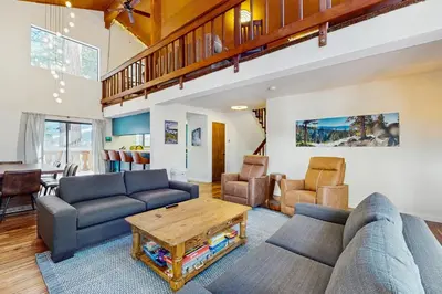a living room with a couch and a table at Pine Hill Hideaway in South Lake Tahoe