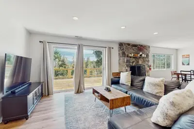 a living room with a couch and a tv at Lakeview Getaway at Rubicon Bay in Tahoma