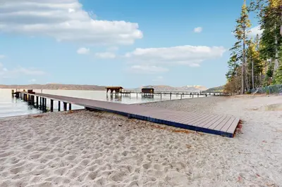 a dock on a beach with sand and water at Lakeview Getaway at Rubicon Bay in Tahoma