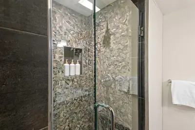 a bathroom with a shower with a glass door at Luxury 3BR 3BA Condo Steps from Canyon Lodge Lift in Mammoth Lakes
