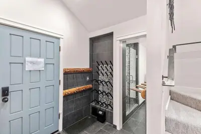 a bathroom with a door and a rack of wine bottles at Luxury 3BR 3BA Condo Steps from Canyon Lodge Lift in Mammoth Lakes