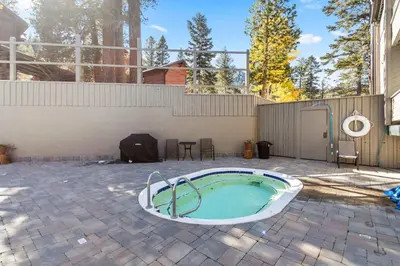a hot tub in the middle of a patio at Luxury 3BR 3BA Condo Steps from Canyon Lodge Lift in Mammoth Lakes