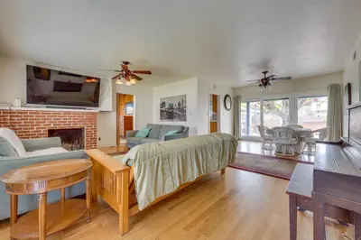 a living room with a couch and a fireplace at Hot Tub, Patio and Outdoor Games at Visalia Home in Visalia