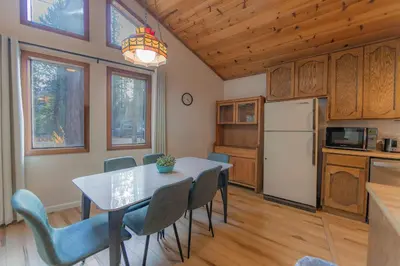 a kitchen and dining room with a table and chairs at Oglala Little Lodge - For 4 in South Lake Tahoe