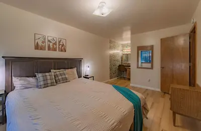 a bedroom with a large bed with a wooden headboard at Oglala Little Lodge - For 4 in South Lake Tahoe