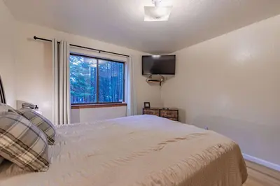 a bedroom with a bed and a large window at Oglala Little Lodge - For 4 in South Lake Tahoe