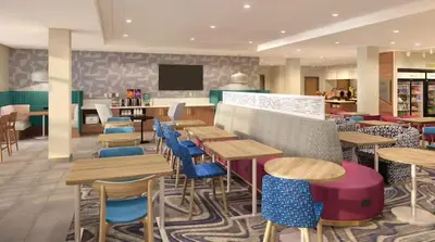 a restaurant with colorful tables and chairs in a cafeteria at Home2 Suites By Hilton Carson City in Carson City