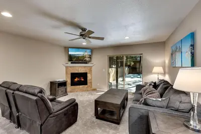 a living room with a couch and a fireplace at Meadow Chalet townhouse in South Lake Tahoe