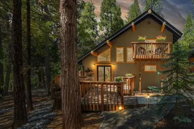 a cabin in the woods with a deck and a balcony at Cozy Cabin and Modern Stay in Arnold Near Bear Valley in Arnold