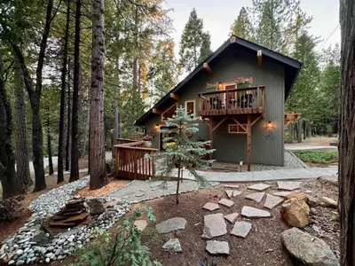a cabin in the woods with a deck and a balcony at Cozy Cabin and Modern Stay in Arnold Near Bear Valley in Arnold