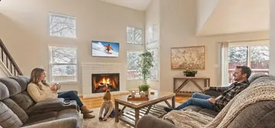 a group of people sitting in a living room with a fireplace at NEW Cityside Stay 3BR Family Retreat Near DT with Patio in Reno