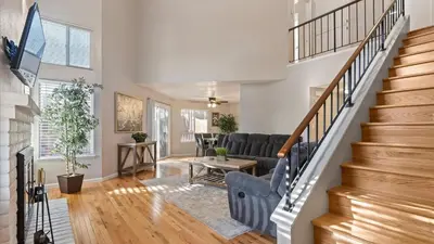 a living room with a staircase and a couch at NEW Cityside Stay 3BR Family Retreat Near DT with Patio in Reno