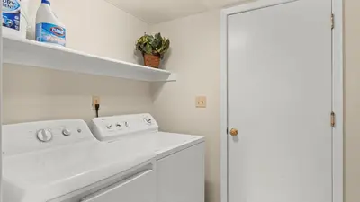 a white kitchen with a sink and a stove at NEW Cityside Stay 3BR Family Retreat Near DT with Patio in Reno