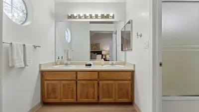 a bathroom with two sinks and a large mirror at NEW Cityside Stay 3BR Family Retreat Near DT with Patio in Reno