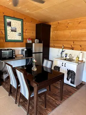 a kitchen with a table and chairs and a kitchen with a sink at Cozy Rustic Cabin on a Working Horse Ranch for a Unique Getaway in Granite Bay, California in Granite Bay