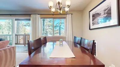 a dining room with a wooden table and chairs at Western Slopes Villas #7 condo in Mammoth Lakes