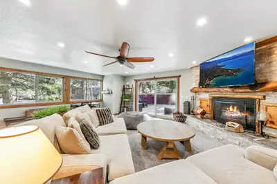 a living room with a couch and a fireplace at Tahoe Cabin - Hot Tub, Fire Pit, Pool Table, minutes from Heavenly in South Lake Tahoe